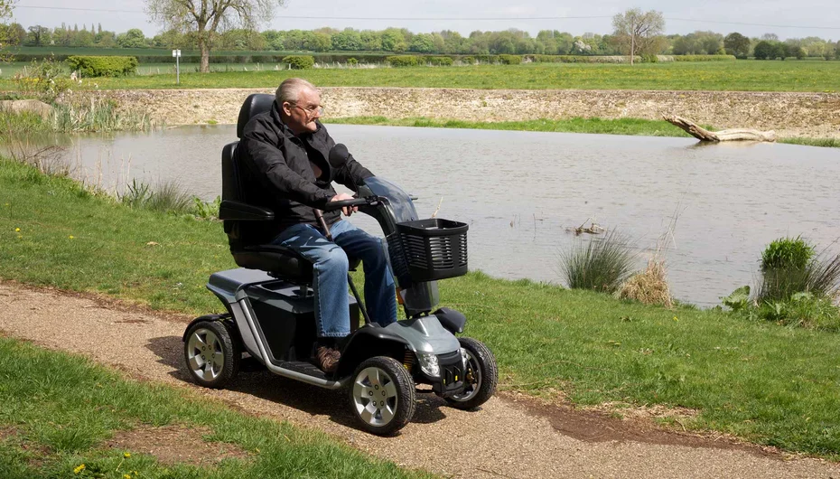 Pride Mobility Colt Executive Luxury Mobility Scooter being driven on rough grounds