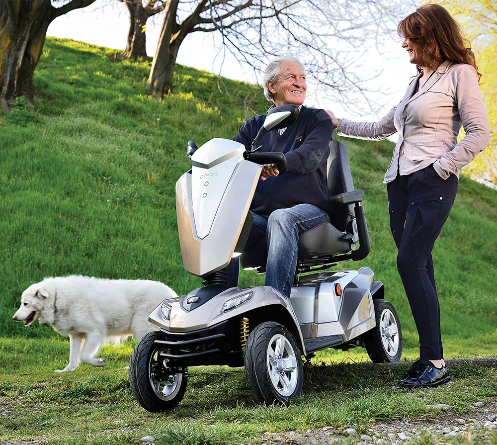 Kymco Mobility Scooter Maxer on rough terrain while walking the dog