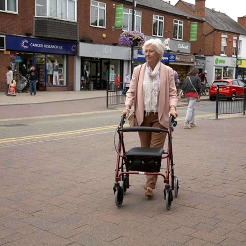 Days 100 Series Rollator A Woman Using it While Out in Russet Orange