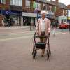 Days 100 Series Rollator A Woman Using it While Out in Russet Orange