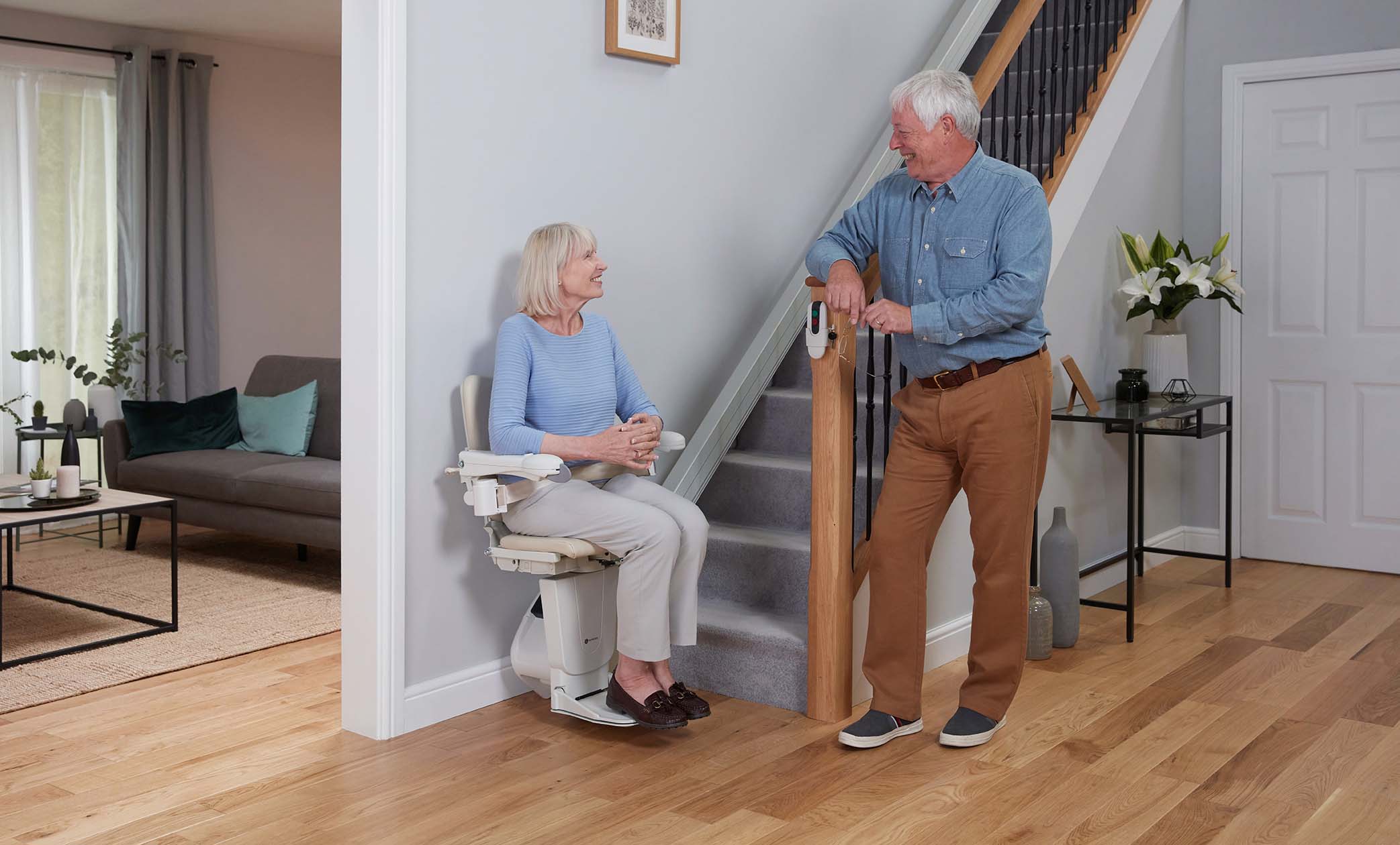 Straight Stairlift Man smiling using their Handicare Stairlift