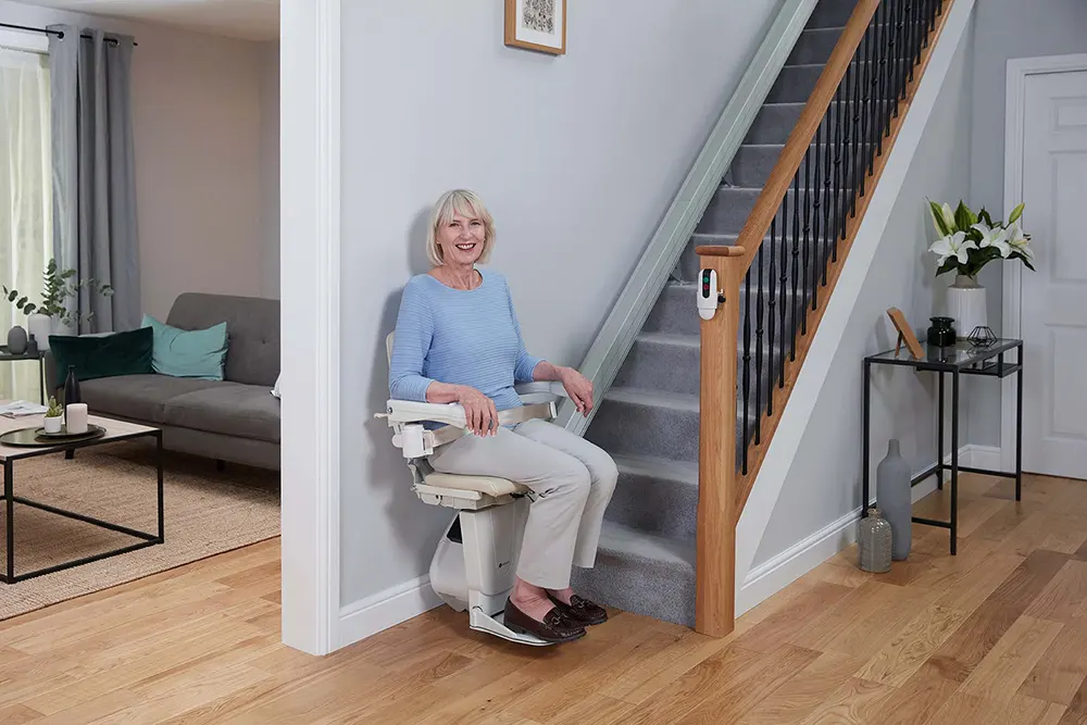 Woman using her Handicare Stairlift 1100