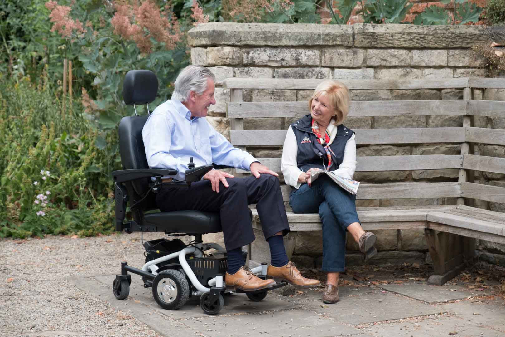 Excel Travelux Quest Midwheel Powerchair Couple enjoying a day out in the park