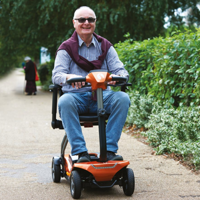 Elderly gentleman riding folding mobility scooters for summer lightweight