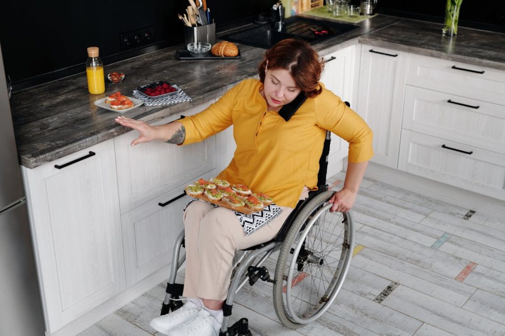 wheelchair user in lowered counter kitchen