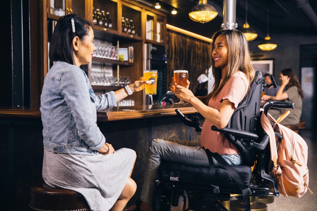 wheelchair user at pub with friend