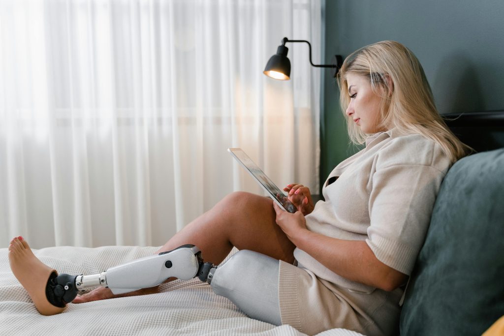 woman with prosthetic leg relaxing in bedroom