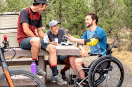 Man in wheelchair having lunch with friends